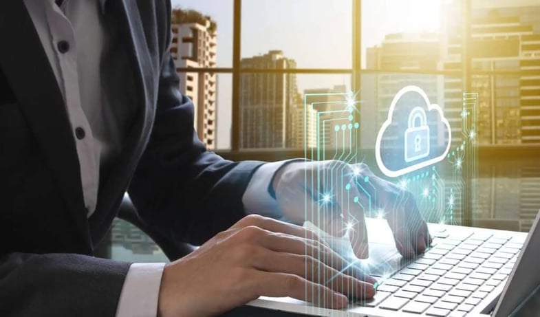 A man sitting in front of a laptop with holographic security lock for provate communication concept.