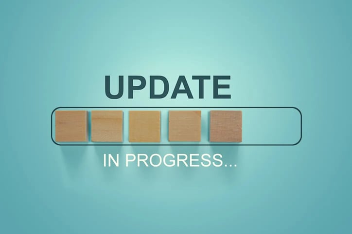 Wooden blocks with the word UPDATE in loading bar progress.