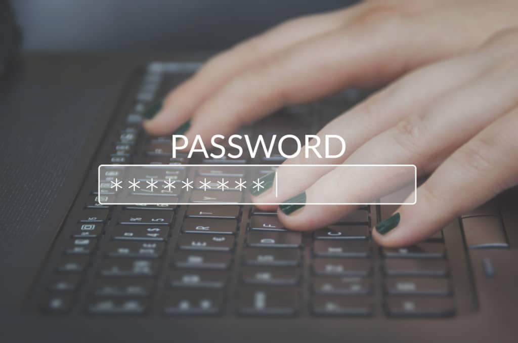 Hands using a keyboard to type in passwords