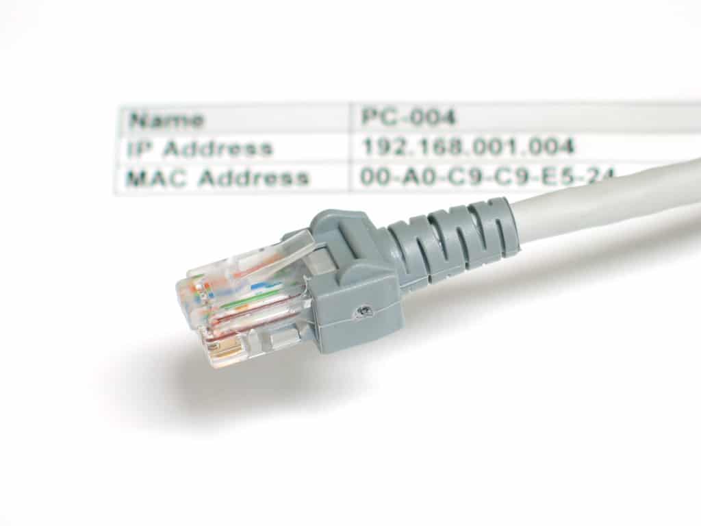 An ethernet cable sitting on a white sheet of paper with IP addresses labeled.