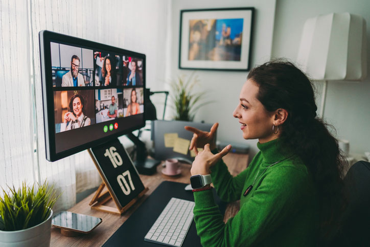 Businesspeople-discussing-business-on-virtual-staff-meeting-during-pandemic