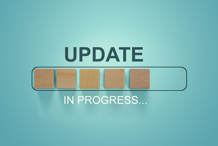 Wooden blocks with the word UPDATE in loading bar progress.